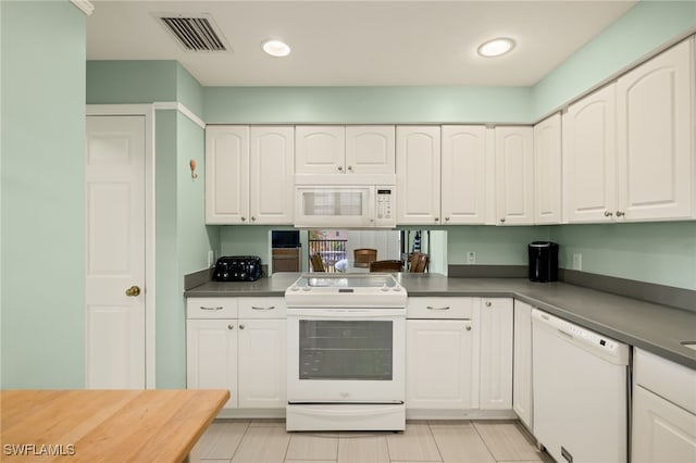 kitchen featuring white cabinetry and white appliances