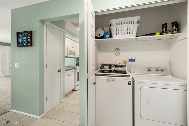 clothes washing area featuring independent washer and dryer