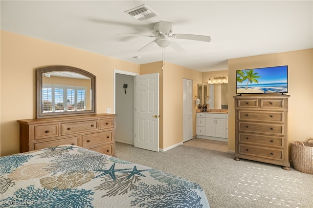 carpeted bedroom with connected bathroom and ceiling fan