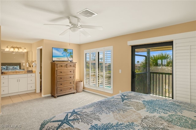 bedroom featuring ceiling fan, light colored carpet, ensuite bathroom, and access to exterior