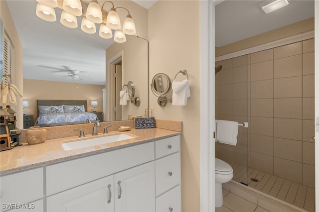 bathroom featuring tile patterned flooring, vanity, ceiling fan, walk in shower, and toilet