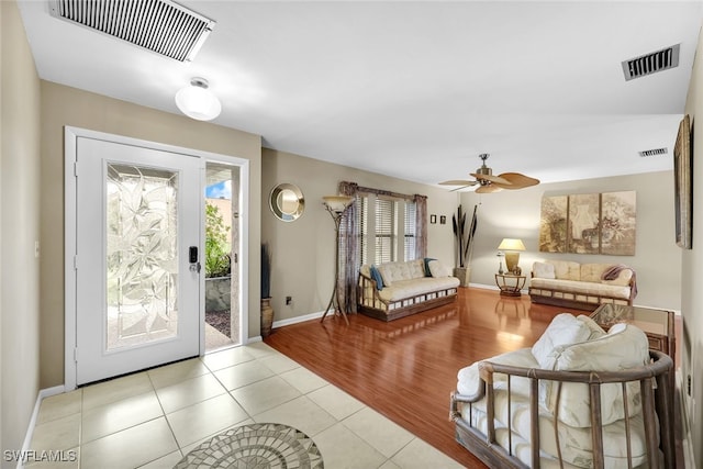 tiled entryway featuring a wealth of natural light and ceiling fan