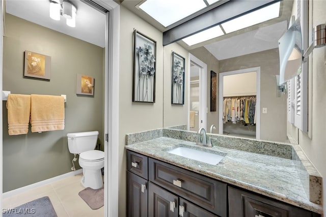 bathroom featuring tile patterned flooring, vanity, and toilet