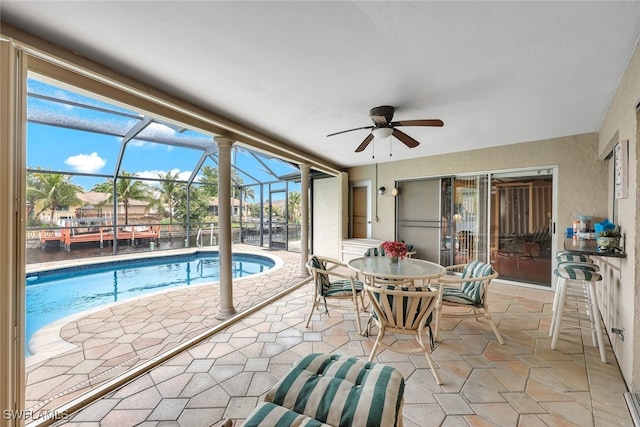 view of pool with a patio, a lanai, and ceiling fan