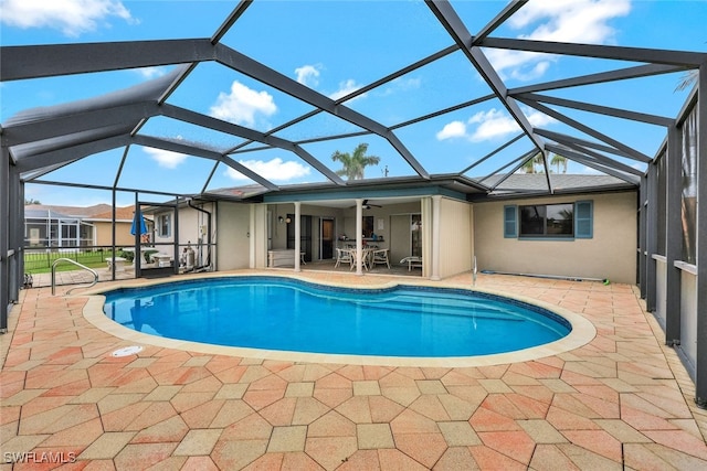 view of pool with a lanai, a patio, and ceiling fan