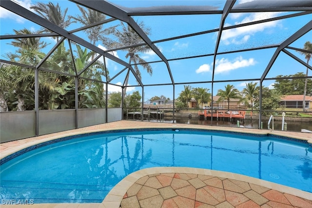 view of swimming pool featuring a water view and a lanai