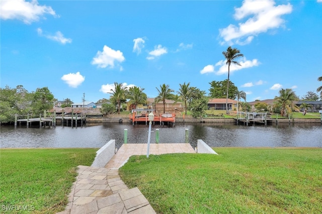 view of dock featuring a water view and a yard