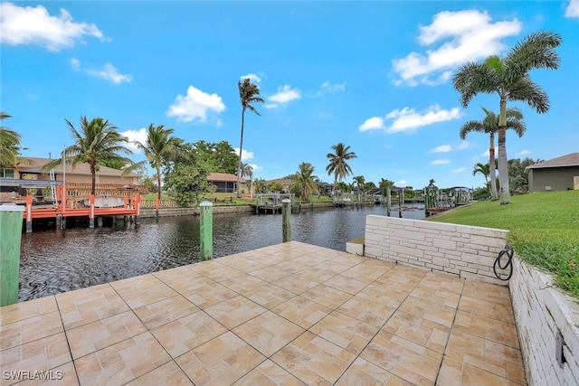 dock area featuring a water view and a lawn