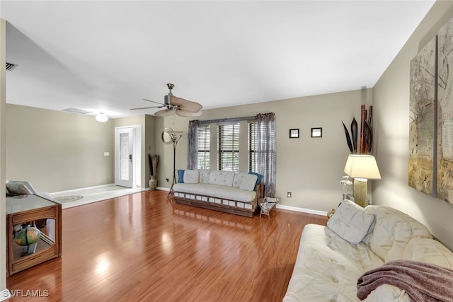 living room featuring wood-type flooring and ceiling fan