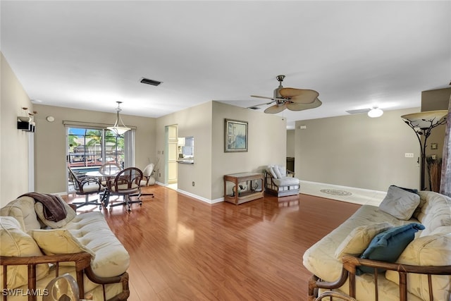 living room with hardwood / wood-style floors and ceiling fan