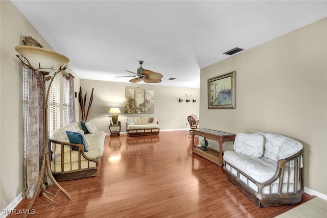 living area with hardwood / wood-style flooring and ceiling fan