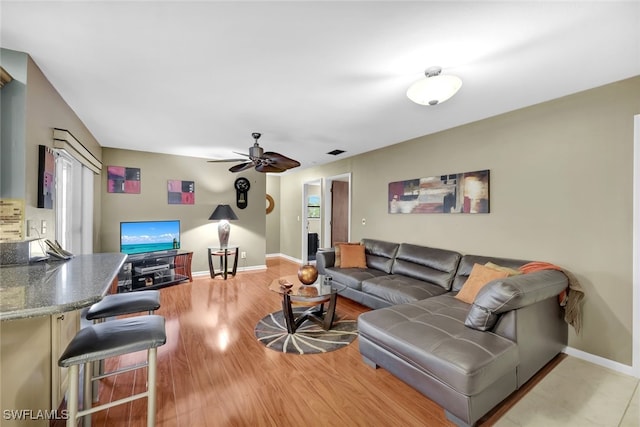 living room featuring ceiling fan and light wood-type flooring