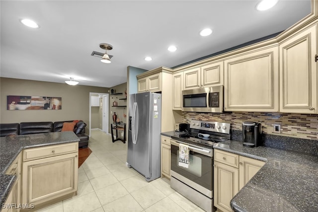 kitchen featuring appliances with stainless steel finishes, light tile patterned floors, and backsplash