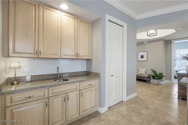 kitchen with crown molding, sink, backsplash, and light brown cabinetry