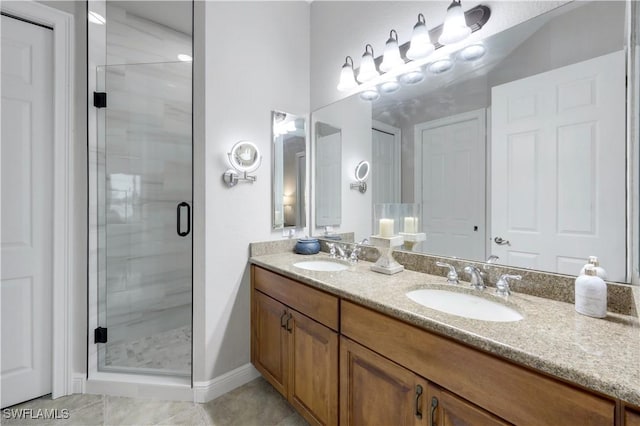 bathroom featuring an enclosed shower, vanity, and tile patterned floors