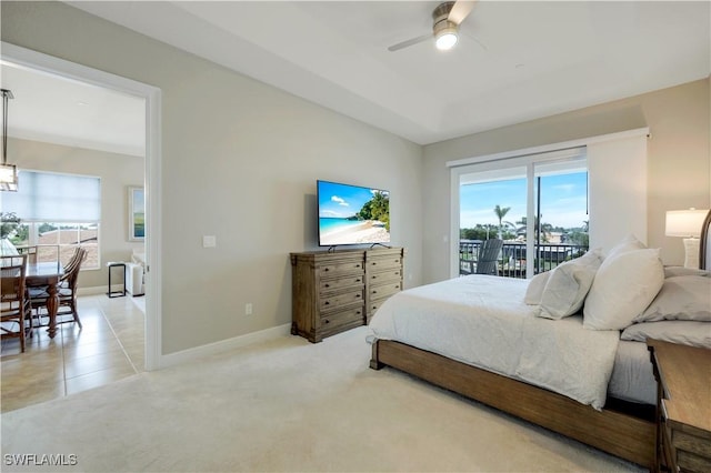 carpeted bedroom featuring multiple windows, access to exterior, and ceiling fan