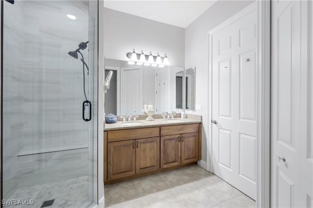 bathroom featuring vanity, tile patterned floors, and walk in shower