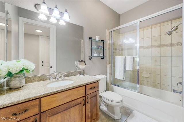 full bathroom featuring enclosed tub / shower combo, vanity, tile patterned flooring, and toilet