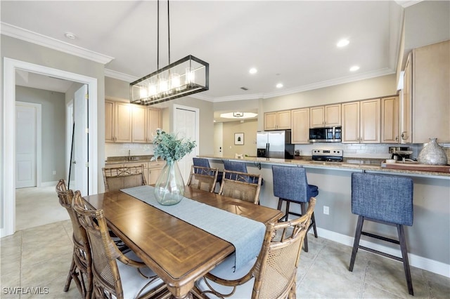 dining area with light tile patterned floors and ornamental molding