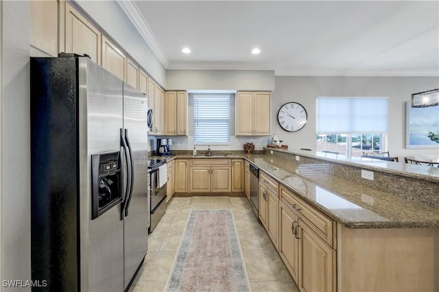 kitchen with sink, dark stone countertops, stainless steel appliances, ornamental molding, and light brown cabinetry