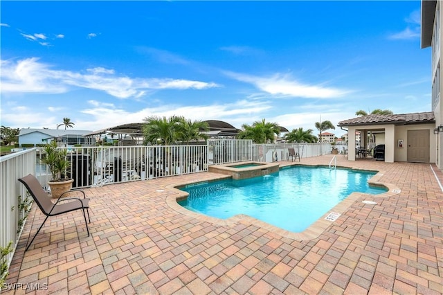 view of pool featuring a community hot tub and a patio