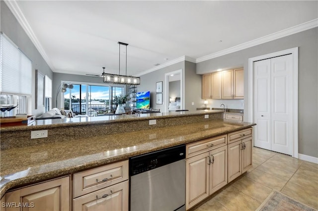 kitchen with dark stone countertops, pendant lighting, stainless steel dishwasher, and light brown cabinets