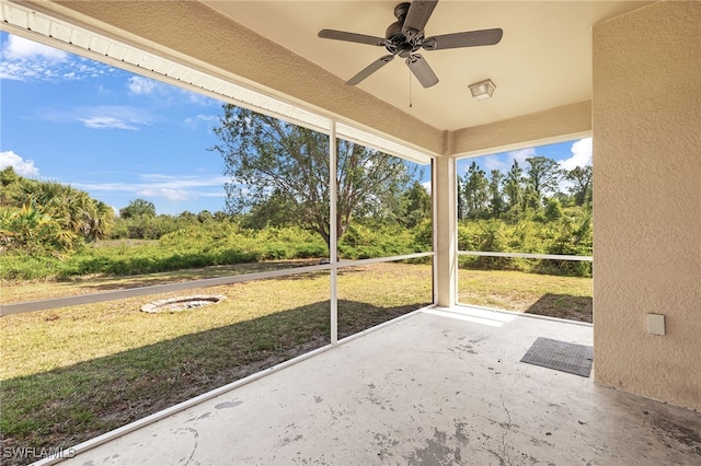 unfurnished sunroom with ceiling fan