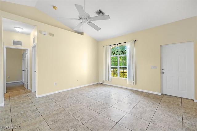 spare room featuring vaulted ceiling, light tile patterned floors, and ceiling fan