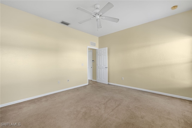 carpeted spare room with ceiling fan