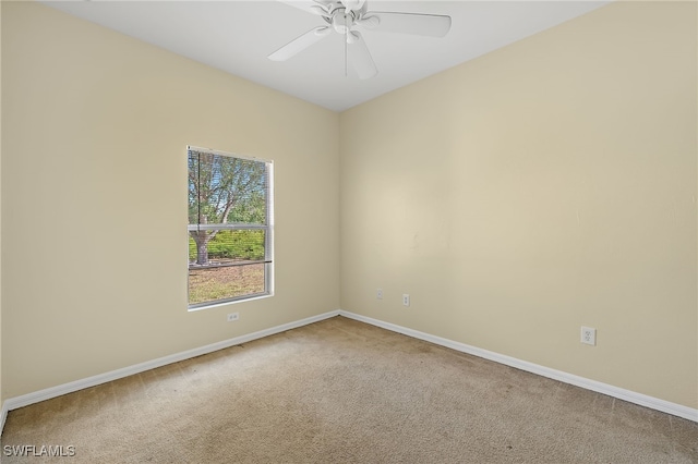 carpeted spare room with ceiling fan