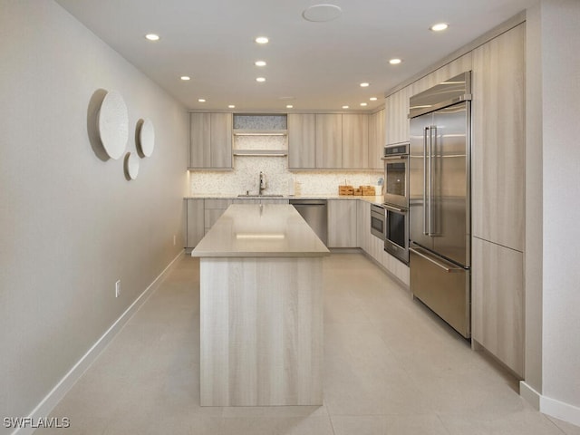 kitchen with decorative backsplash, modern cabinets, appliances with stainless steel finishes, light brown cabinetry, and open shelves