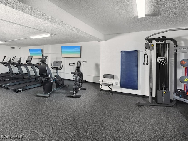 gym featuring a textured ceiling