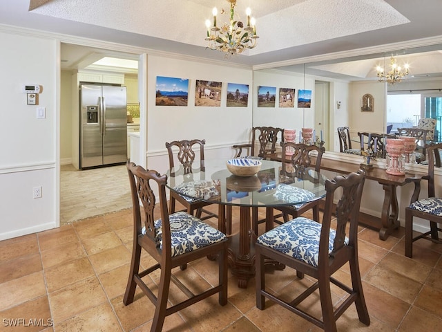 dining room with baseboards, a raised ceiling, a textured ceiling, crown molding, and a chandelier