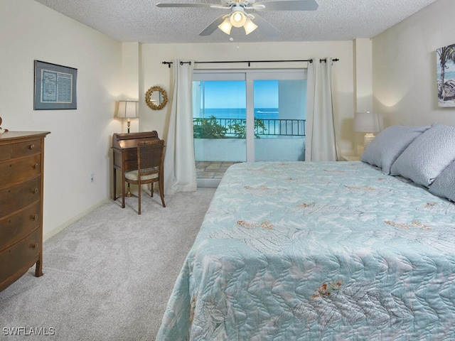 carpeted bedroom with a textured ceiling, access to outside, and a ceiling fan