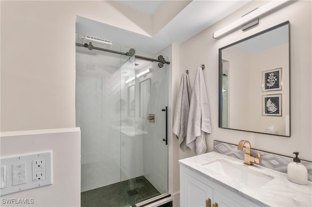 bathroom featuring vanity and an enclosed shower