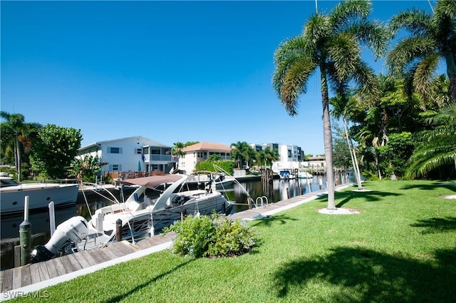 view of community with a water view, a yard, and a dock