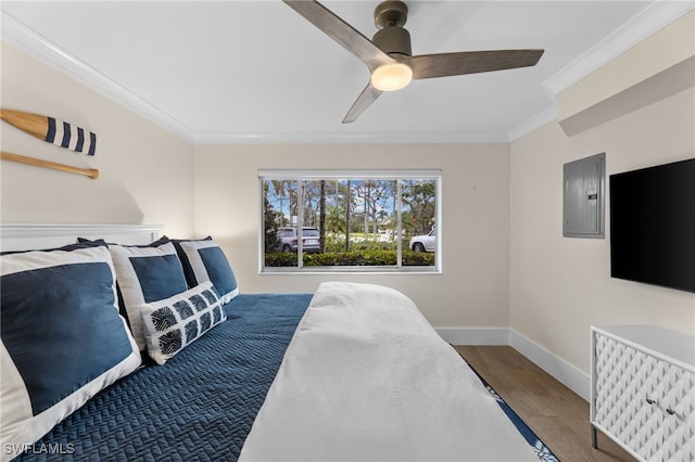 bedroom featuring crown molding, wood-type flooring, electric panel, and ceiling fan