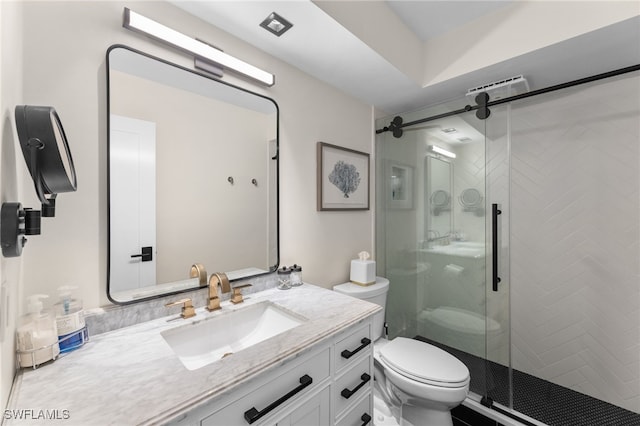 bathroom featuring vanity, toilet, and a shower with shower door