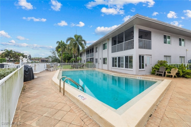 view of swimming pool featuring a patio area