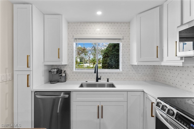 kitchen with white cabinetry, sink, and appliances with stainless steel finishes