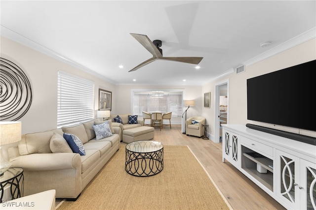 living room featuring crown molding, ceiling fan, a wealth of natural light, and light wood-type flooring