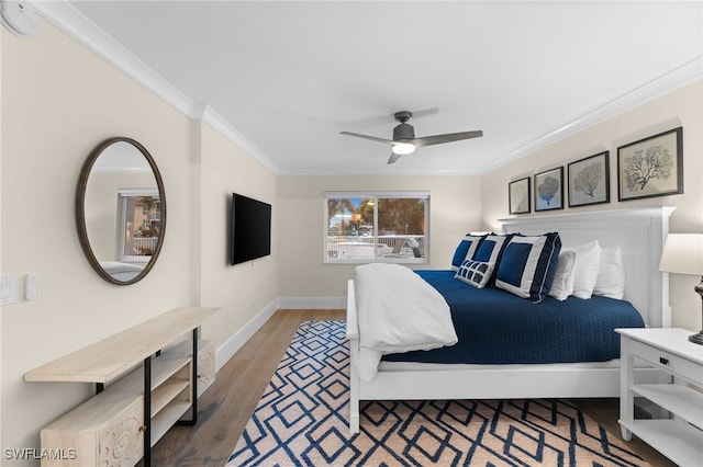 bedroom featuring ceiling fan, ornamental molding, and wood-type flooring