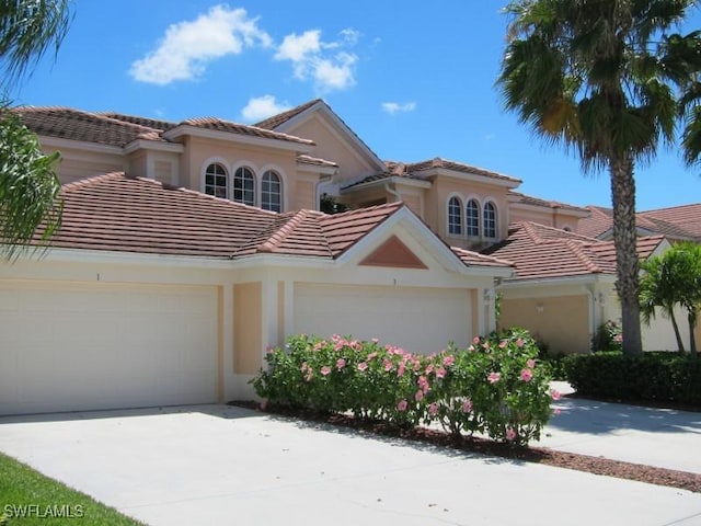 mediterranean / spanish home featuring a garage