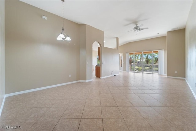 unfurnished room featuring light tile patterned floors, vaulted ceiling, baseboards, and ceiling fan with notable chandelier