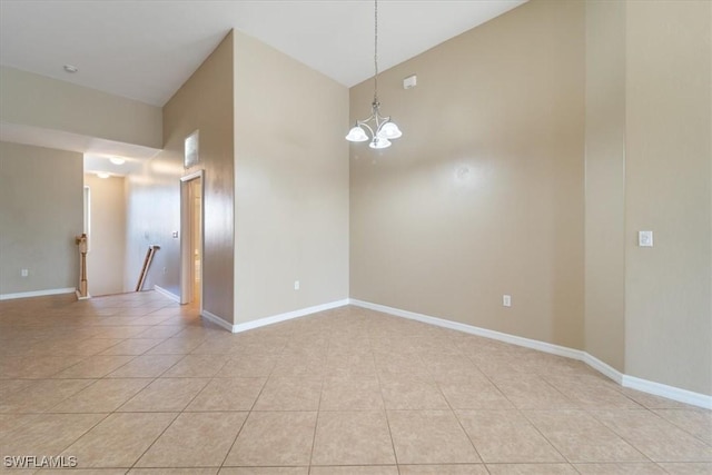 unfurnished room featuring light tile patterned floors, baseboards, and a chandelier