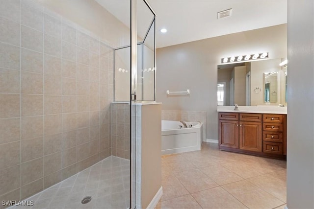 full bath featuring a garden tub, vanity, visible vents, tile patterned floors, and a stall shower