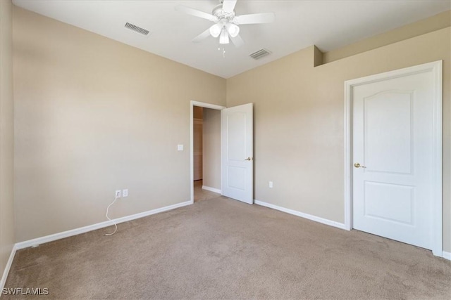 unfurnished bedroom featuring a ceiling fan, light colored carpet, visible vents, and baseboards