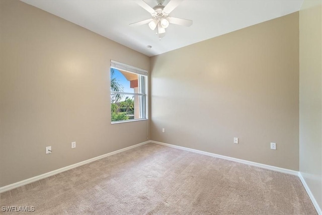 spare room featuring carpet flooring, ceiling fan, and baseboards