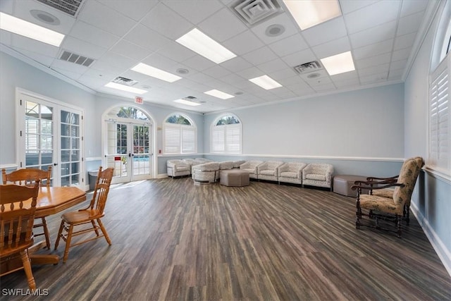 living area with french doors, plenty of natural light, and visible vents