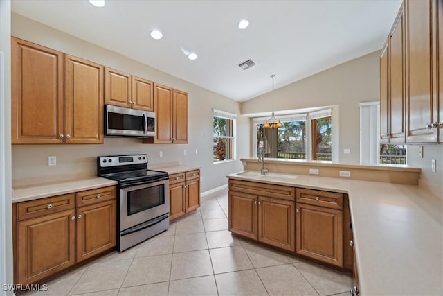 kitchen featuring decorative light fixtures, visible vents, light countertops, appliances with stainless steel finishes, and a sink